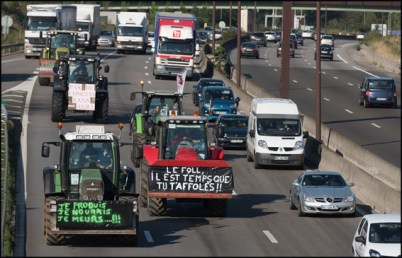 Farmers holding signs on their tractor to Paris to take part in a national demonstration of farmers in Paris. Paris, FRANCE-03/09/2015