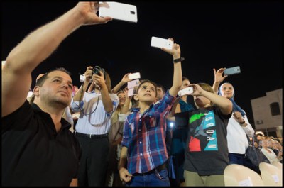 Pupils takes pictures with phones. French Prime Minister, Manuel Valls inaugurates the french school Deir Ghbar. Amman, JORDAN-11/10/2015