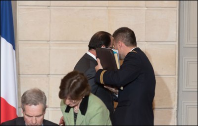 Hollande talking with her aide-de-camp. Iranian President Hassan Rouhani (Rear L) and French President Francois Hollande (Rear R) attend a bilateral political, cultural and economic agreements signing ceremony at the Elysee Palace Paris, FRANCE-28/01/2016