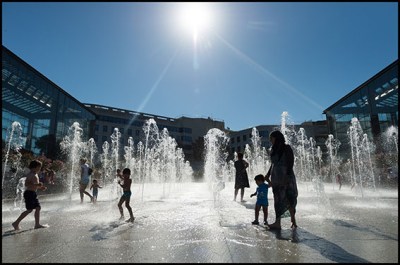 People play with jets of water at the garden Andre Citroen during the heat wave (canicule).  Paris, FRANCE-25/09/2016